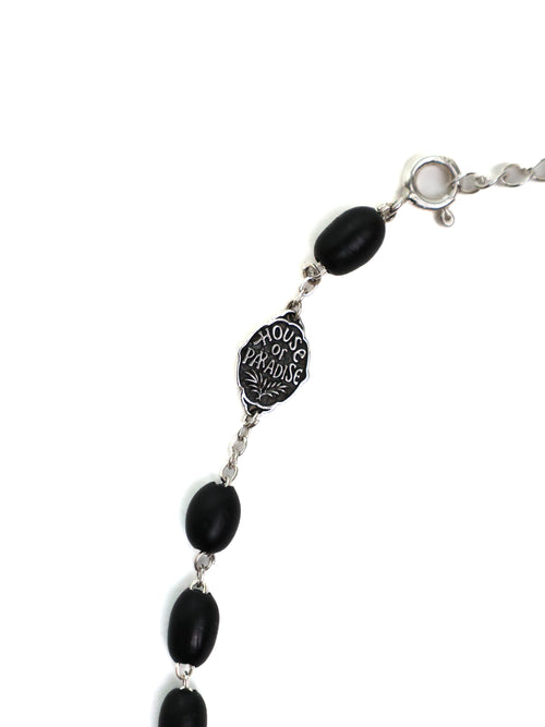 Bracelet with black beads and a silver clasp on a white background