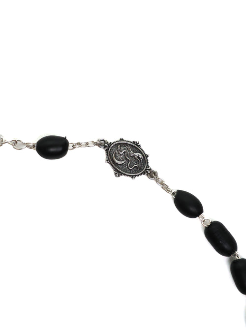 Bracelet with black beads and silver clasp on a white background