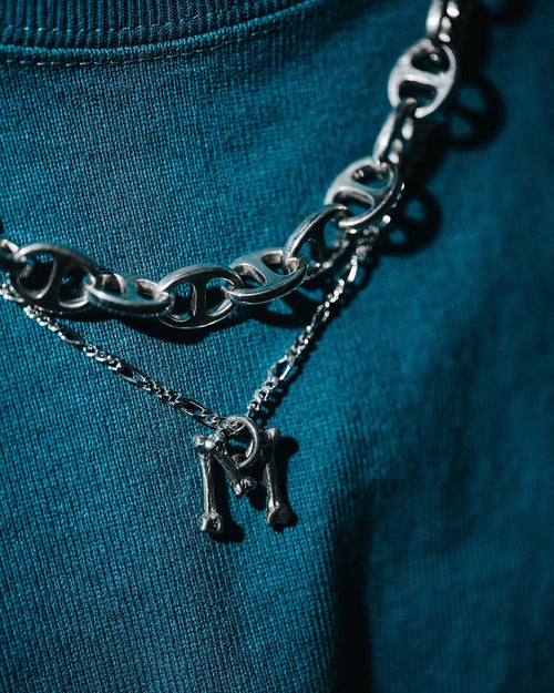 MAPLE Bone Chain hanging with MAPLE Chain link chain on blue sweater