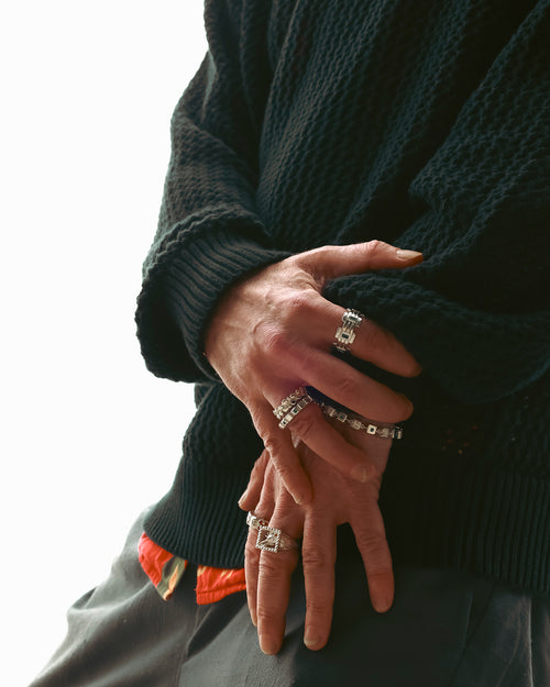 FW24 Editorial close up of hands wearing multiple rings & one bracelet