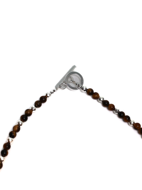 Bracelet with brown beads and a silver clasp on a white background