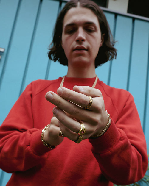 Zane Coppard adjusting a 14K Gold bracelet