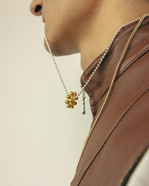 Side view of a model wearing MAPLE orbit necklace