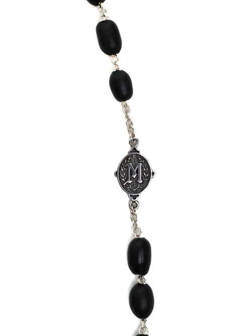 Necklace with black beads and a silver clasp on a white background