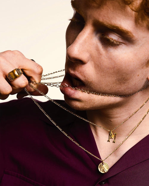 Man wearing MAPLE 3 chains pulling them across his chin with his hand