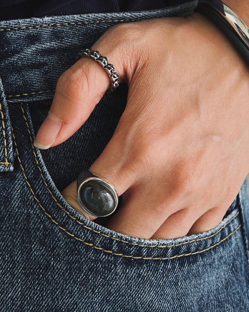 Closeup of hand in denim pocket wearing MAPLE laugh Now Cry Later ring on thumb