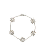 Silver bracelet with sun inspired pendants on a white background