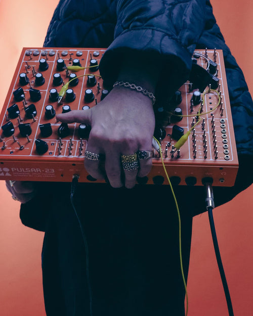 MAN carrying Soma Laboratory Pulsar-23 wearing MAPLE rings & bracelets