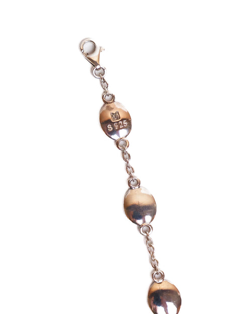 Bracelet with silver medallions on a white background