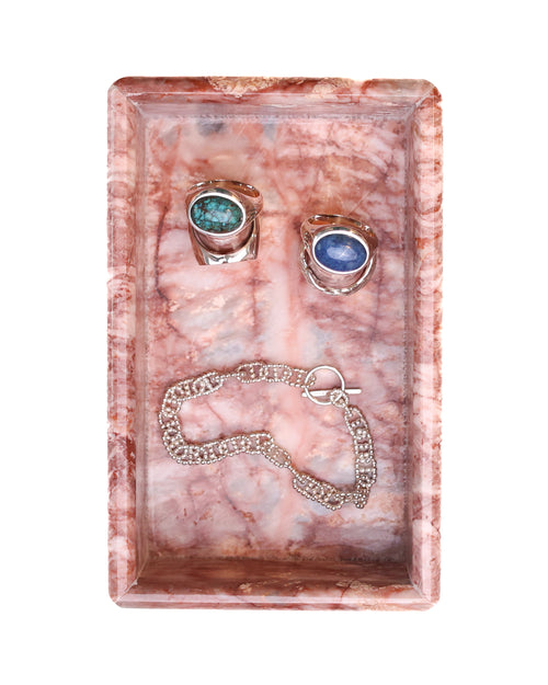 Jewelry set with earrings and a bracelet in a pink marble jewelry box