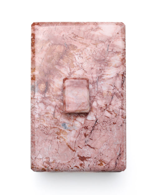 Pink marble jewelry box lid on a white background