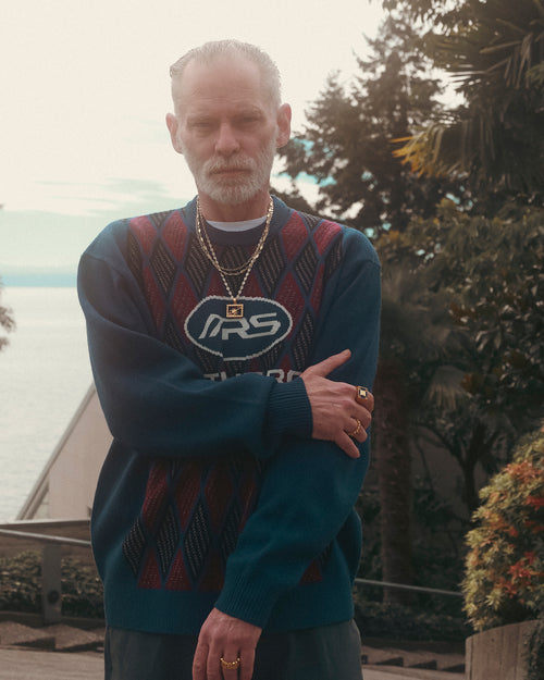 FW24 Editorial man standing in front of trees and West Vancouver coastline wearing MAPLE 14K Gold rings chains & necklaces