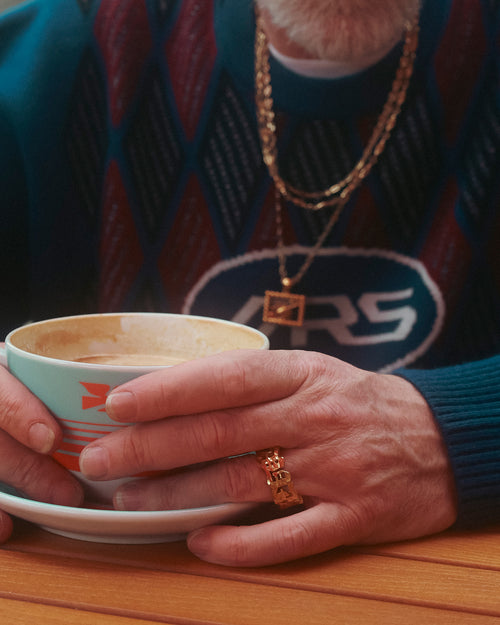 FW24 Editorial closeup of hands holding a latte while wearing MAPLE 14K gold paradiso ring