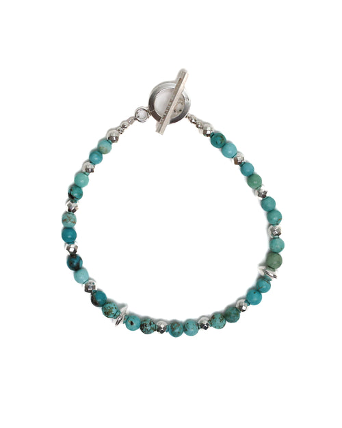 Bracelet with turquoise beads and silver clasp on a white background